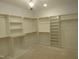 Large walk-in closet featuring custom shelves and hanging rods at 2590 Silas Peak Ln, Apex, NC 27523