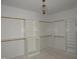 Spacious walk-in closet with custom shelving and ample storage, illuminated by a stylish light fixture at 2590 Silas Peak Ln, Apex, NC 27523