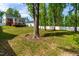 Spacious backyard with mature trees, a wooden deck, and plenty of room for outdoor enjoyment at 27 Ashley Woods Ct, Clayton, NC 27527