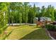 Well-maintained backyard with a wooden deck and lush greenery, providing a private and tranquil outdoor space at 27 Ashley Woods Ct, Clayton, NC 27527