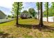 Expansive backyard featuring a wooden deck and lush greenery, creating a serene and private outdoor setting at 27 Ashley Woods Ct, Clayton, NC 27527