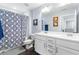 Bathroom featuring a double vanity, toilet, and blue patterned shower curtain at 27 Ashley Woods Ct, Clayton, NC 27527