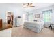 Light-filled bedroom with walk-in closet, ceiling fan, and two windows at 27 Ashley Woods Ct, Clayton, NC 27527