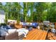 Relaxing deck area with comfortable seating, fire pit, and grill, ideal for outdoor living and entertaining at 27 Ashley Woods Ct, Clayton, NC 27527