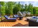Outdoor deck featuring a grill, seating, and a fire pit table, perfect for outdoor gatherings at 27 Ashley Woods Ct, Clayton, NC 27527