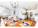 Open-concept dining area with stylish light fixture and connection to a modern kitchen at 27 Ashley Woods Ct, Clayton, NC 27527