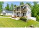 Two-story home with double balconies, a two car garage, and a green lawn at 27 Ashley Woods Ct, Clayton, NC 27527
