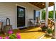 Welcoming front porch featuring stylish decor, comfortable seating, and a 'Hello' doormat at 27 Ashley Woods Ct, Clayton, NC 27527