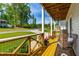 Inviting front porch with comfortable seating and colorful potted plants on a sunny day at 27 Ashley Woods Ct, Clayton, NC 27527