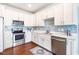 Bright kitchen featuring white cabinets, stainless steel appliances, and modern finishes at 27 Ashley Woods Ct, Clayton, NC 27527