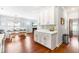 View of dining room, living room, and kitchen with white cabinets and tile backsplash at 27 Ashley Woods Ct, Clayton, NC 27527