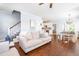 Bright, open living space showcasing a staircase, dining area, and modern furnishings at 27 Ashley Woods Ct, Clayton, NC 27527