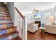 Stylish living room with fireplace, decorative staircase, and comfortable furnishings at 27 Ashley Woods Ct, Clayton, NC 27527