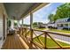 Charming porch featuring wood flooring, comfortable seating, and scenic views of the neighborhood at 27 Ashley Woods Ct, Clayton, NC 27527