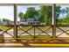 Covered porch featuring wood railings and a view of the front yard and neighboring homes at 27 Ashley Woods Ct, Clayton, NC 27527