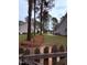 Large yard with mature trees and a glimpse of the water beyond the fence, a scenic view at 282 W Thicket Dr, Angier, NC 27501