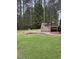 Large, grassy backyard featuring a deck with a grill and plenty of space for activities at 282 W Thicket Dr, Angier, NC 27501