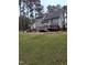 A large backyard with a stone patio at 282 W Thicket Dr, Angier, NC 27501