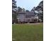 Spacious backyard featuring a large deck and patio area, perfect for outdoor entertaining at 282 W Thicket Dr, Angier, NC 27501
