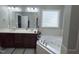 Bright bathroom featuring double vanity, soaking tub and window block for natural light at 282 W Thicket Dr, Angier, NC 27501