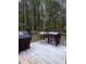 Deck with outdoor cooking area and wooded scenery at 282 W Thicket Dr, Angier, NC 27501