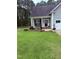 Home featuring a well-manicured front yard and covered front porch at 282 W Thicket Dr, Angier, NC 27501