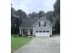 Charming home with a two-car garage, well-manicured lawn, and inviting front porch at 282 W Thicket Dr, Angier, NC 27501