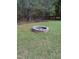 Backyard with a charming stone fire pit, perfect for outdoor gatherings and relaxation at 282 W Thicket Dr, Angier, NC 27501