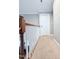 Hallway with carpeted floor, white trim, and wooden banister at 282 W Thicket Dr, Angier, NC 27501
