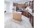 Well-equipped kitchen featuring dark cabinets and movable wooden island at 282 W Thicket Dr, Angier, NC 27501