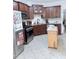 Functional kitchen with dark cabinets, stainless appliances, and a kitchen island at 282 W Thicket Dr, Angier, NC 27501