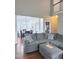 Spacious living room featuring a grey sectional sofa with dining area view at 282 W Thicket Dr, Angier, NC 27501