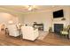 Bright living room with fireplace, wood floors, white armchairs, and decorative elements at 3017 Dog Rose Dr # 169, Durham, NC 27703