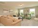 Spacious upstairs living area includes a tan sofa with black pillows and two green cushioned chairs at 3017 Dog Rose Dr # 169, Durham, NC 27703