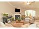 This living room features a fireplace, television, comfortable seating, and large window for natural light at 3017 Dog Rose Dr # 169, Durham, NC 27703