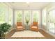 This sunroom features multiple windows, comfortable seating, and a view of the outdoors at 3017 Dog Rose Dr # 169, Durham, NC 27703