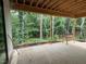 Covered porch with exposed wood rafters overlooking a private backyard full of mature trees at 3324 Founding Place, Raleigh, NC 27612