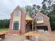Craftsman-style brick home under construction with a side-entry garage and architectural trim at 3324 Founding Place, Raleigh, NC 27612