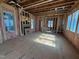 Unfinished living room showcasing window framing, pink insulation, and subflooring in natural light at 3324 Founding Place, Raleigh, NC 27612