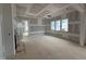 Unfinished living room with three windows and doorway view to the next room at 3324 Founding Place, Raleigh, NC 27612