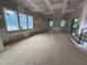 Spacious living room featuring large windows offering ample natural light, awaiting personalization at 3324 Founding Place, Raleigh, NC 27612