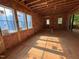 Unfinished living room showing wall and window framing with insulation, plus sliding door to the backyard at 3324 Founding Place, Raleigh, NC 27612