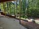 View from covered patio, with wooden support structure and equipment like ladders and wheelbarrows at 3324 Founding Place, Raleigh, NC 27612