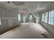 Unfinished room featuring drywall and a variety of windows letting in lots of natural light at 3324 Founding Place, Raleigh, NC 27612