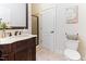 Elegant bathroom features a furniture-style vanity with a marble countertop and a decorative mirror at 3612 Griffice Mill Rd, Raleigh, NC 27610