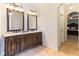 Bathroom features a large vanity with double sinks, tile floor and arched entry to bedroom at 3612 Griffice Mill Rd, Raleigh, NC 27610