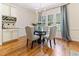 Bright and airy dining area with a glass-top table, upholstered chairs, and natural light from large windows at 3612 Griffice Mill Rd, Raleigh, NC 27610