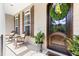 Inviting front porch featuring a decorative front door, rocking chairs, and potted plants at 3612 Griffice Mill Rd, Raleigh, NC 27610