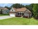 Charming stone and siding home with well-manicured lawn and attached two car garage at 3612 Griffice Mill Rd, Raleigh, NC 27610