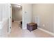 Light hallway featuring beige carpet and walls, with a decorative woven storage chest at 3612 Griffice Mill Rd, Raleigh, NC 27610